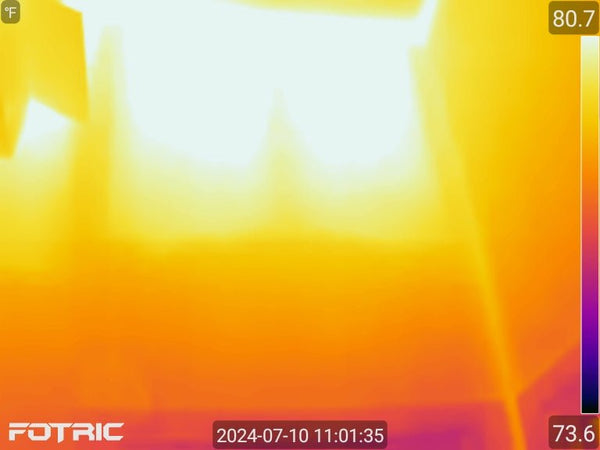 Thermal imaging scan (FOTRIC camera) of an attic ceiling displaying a heat spectrum ranging from 73.6°F to 80.7°F.